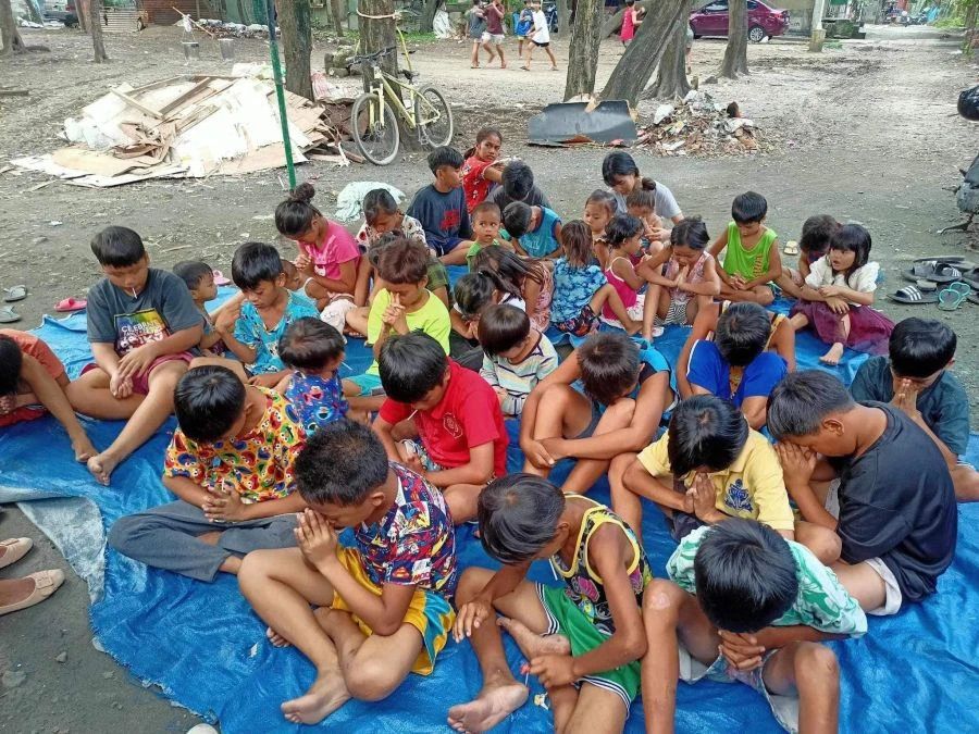 Children gathered outdoors for a community outreach program in Angono, Rizal