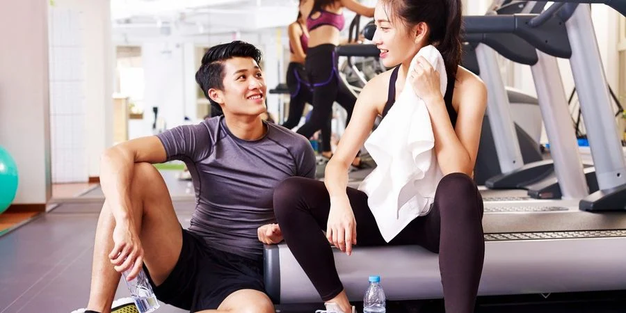 Two colleagues enjoying a break after exercise