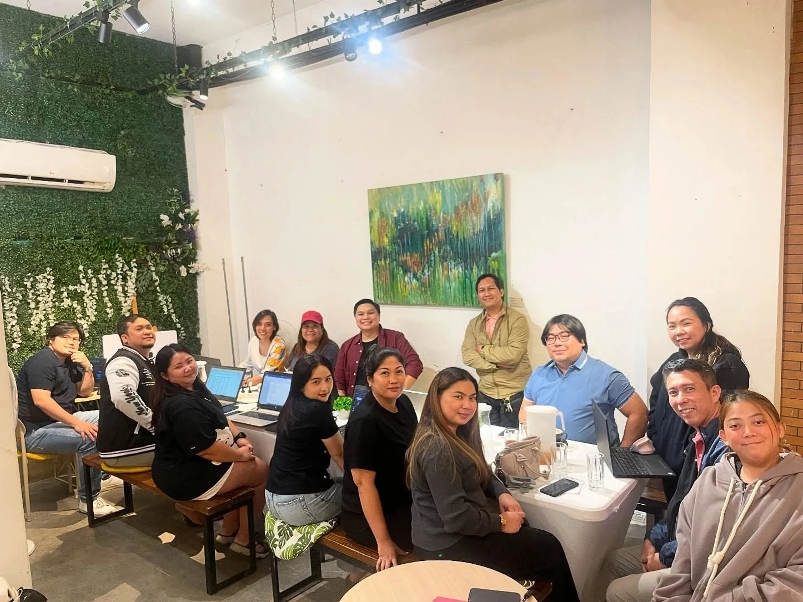 VH teammates gathered around a table for a coffee meeting